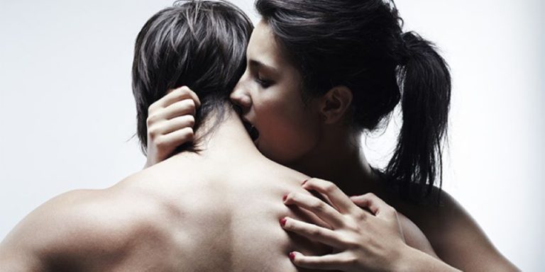 pareja besándose en el cuello durante los preliminares en un momento íntimo