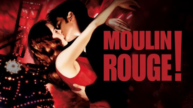 Pareja besándose apasionadamente en escena del musical Moulin Rouge con iluminación roja intensa